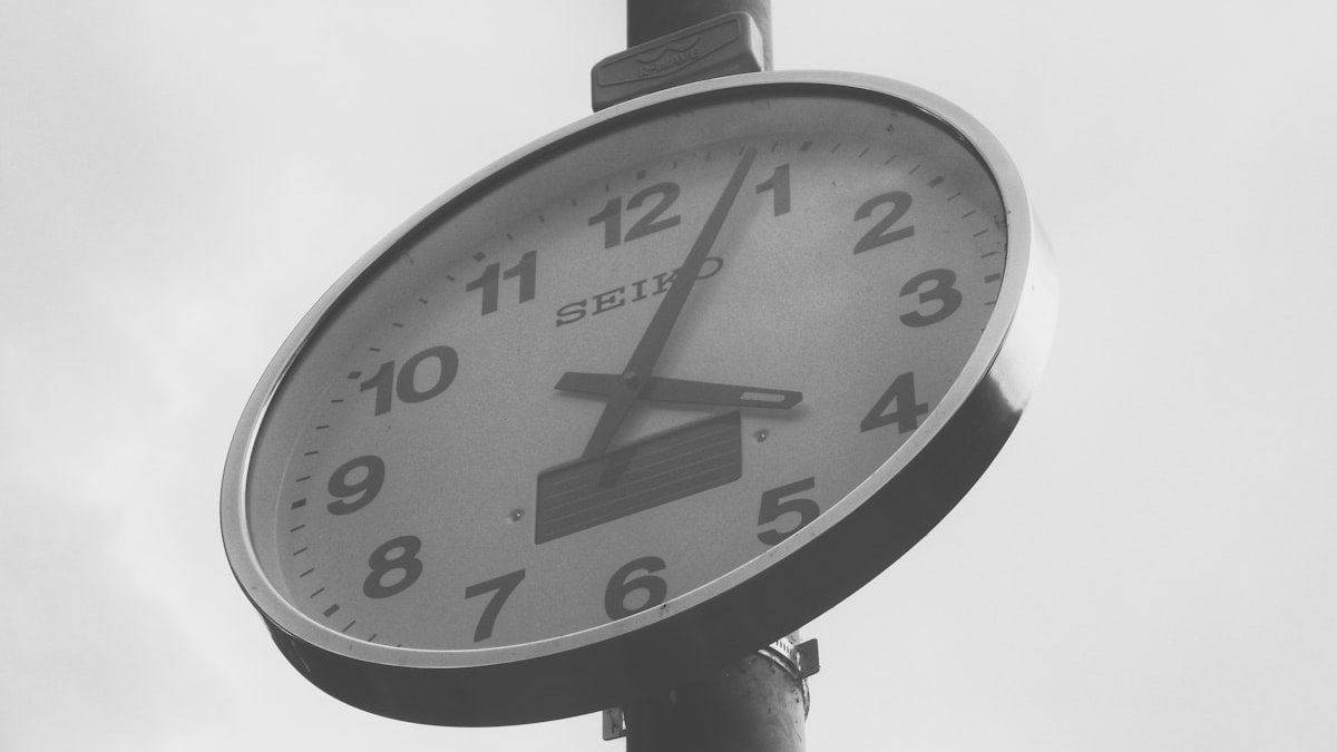 Grayscale photo of wall clock displaying 4:04. — a Sleep Finally guide to The Freed Half Hour: What to Do After Screens Go Off.