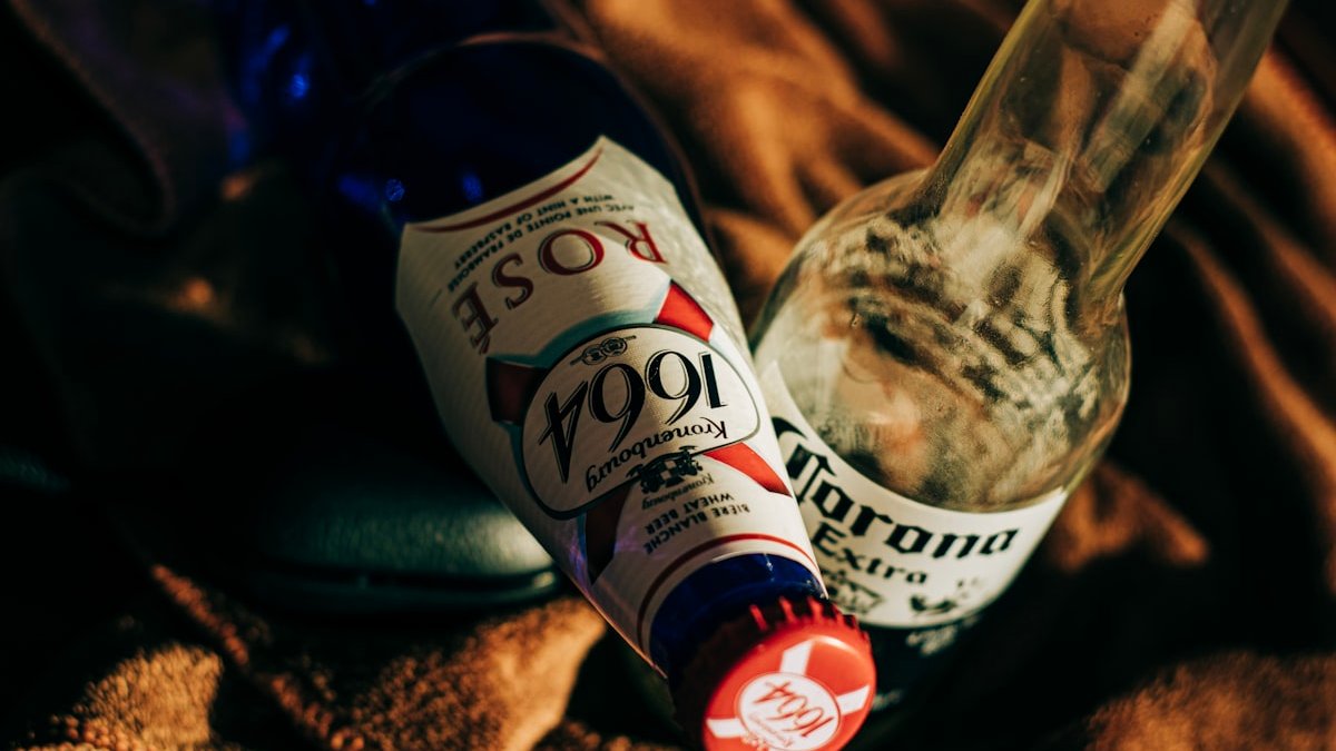 Two clear glass bottles on brown textile. — a Sleep Finally guide to The Two-Week No-Alcohol Sleep Experiment.