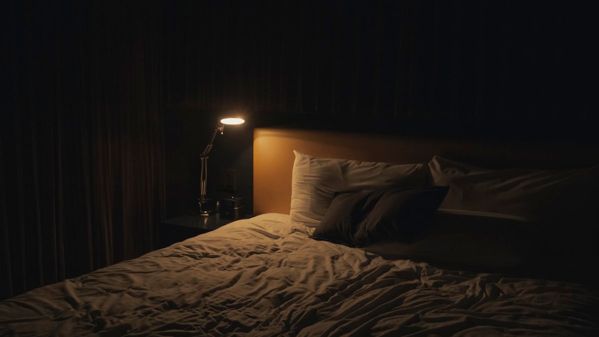 Table lamp turned-on near bed. — a Sleep Finally guide to When a Nap Costs You the Night: The Pressure Math.