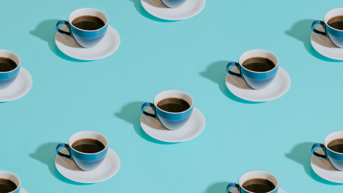 White ceramic teacup on white ceramic saucer. — a Sleep Finally guide to When Matters More Than How Much: Caffeine Timing.