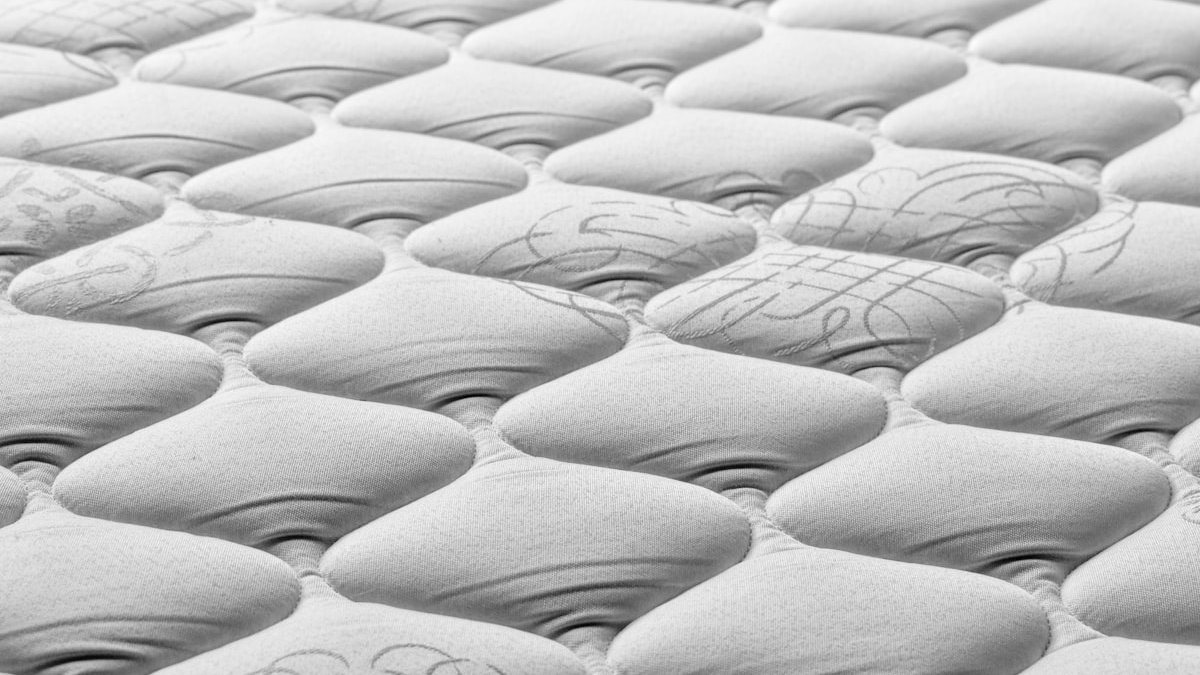 A close up of a mattress that has been made. — a Sleep Finally guide to When Should You Replace Your Mattress.