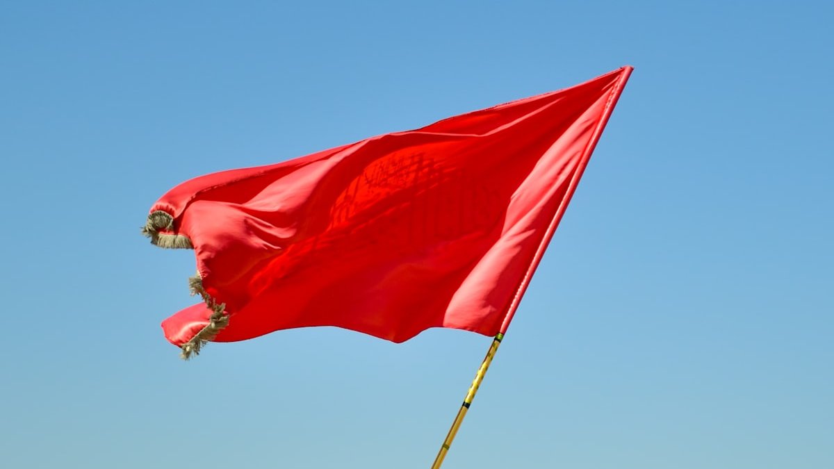 Red flag on pole under blue sky during daytime. — a Sleep Finally guide to Sleep Paralysis Red Flag: When Episodes Deserve a Doctor.
