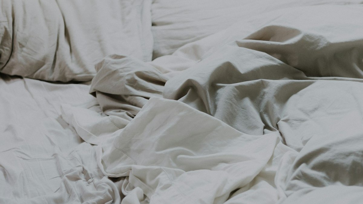 White pillows and bed comforter. — a Sleep Finally guide to when to replace your mattress.