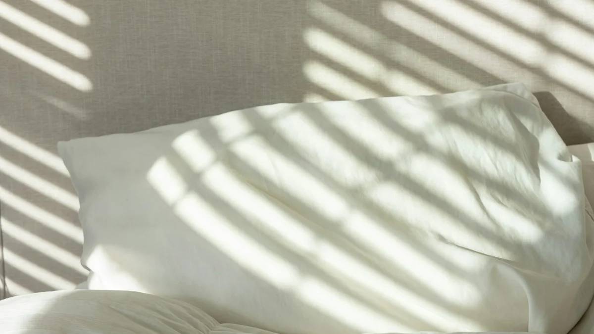a bed with white sheets and white pillows — a Sleep, Finally guide to Why Consistency Beats Duration for Sleep