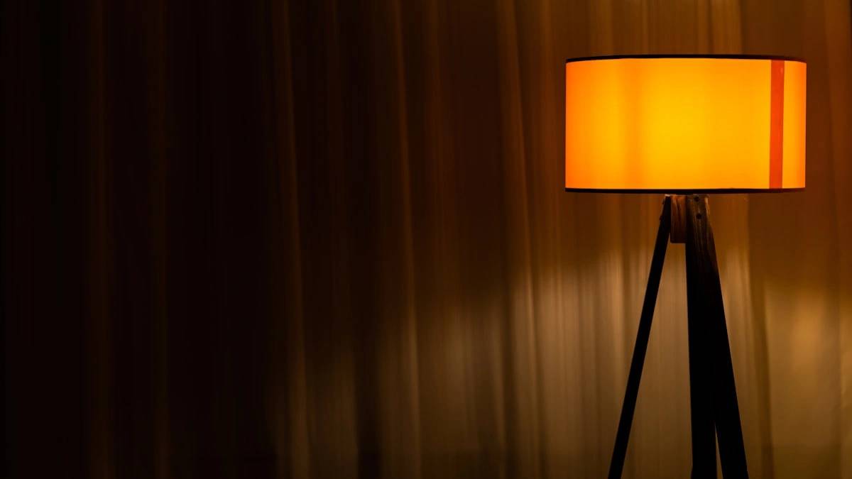 brown table lamp turned on near brown curtain — a Sleep, Finally guide to Why Dim Evenings Make Morning Light Work Better