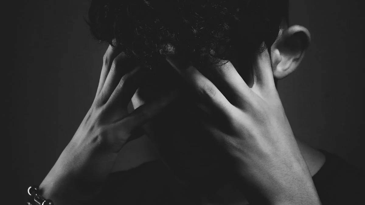 grayscale photo of man covering his face with his hand — a Sleep, Finally guide to Why Nerves Keep You Awake Before Big Events