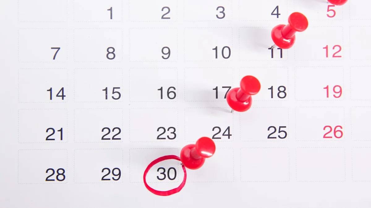 a calendar with red push buttons pinned to it — a Sleep, Finally guide to Why Sleep Gets Harder the Week Before Your Period