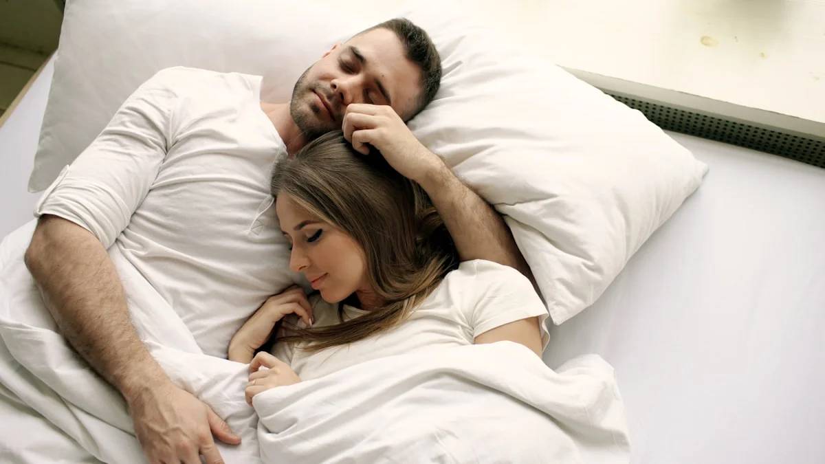 Couple sleeping peacefully in bed together — a Sleep, Finally guide to Why Snoring Gets Worse After a Drink or Two