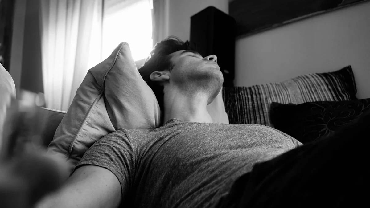 grayscale photo of man laying on bed — a Sleep, Finally guide to Why Snoring That Stops and Starts Is a Red Flag