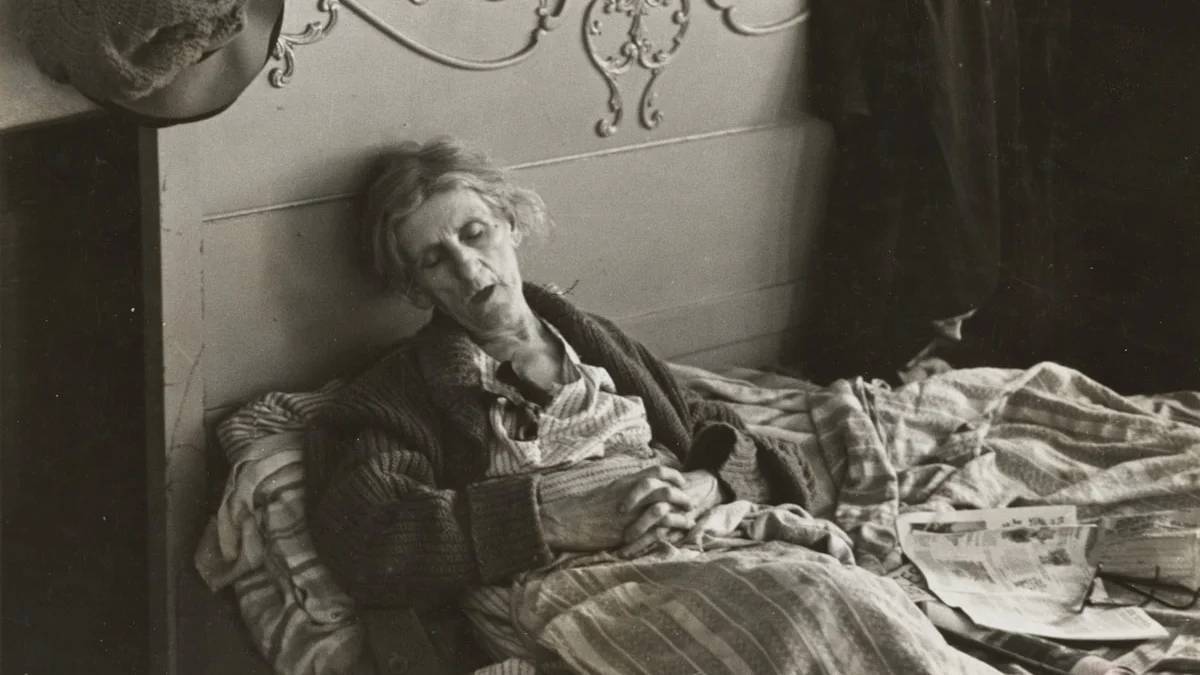 grayscale photography of woman lying on bed — a Sleep, Finally guide to Why Waking More at Night Is Normal as You Age
