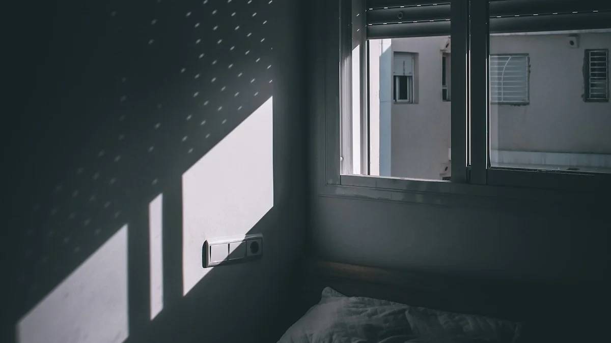 grayscale photo of bed near window — a Sleep, Finally guide to Why Your Bedroom Should Be Dark (and How Dark Is Enough)
