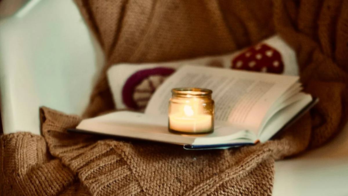 a candle and a book on a chair — a Sleep, Finally guide to Why Your Brain Needs a Wind-Down Hour