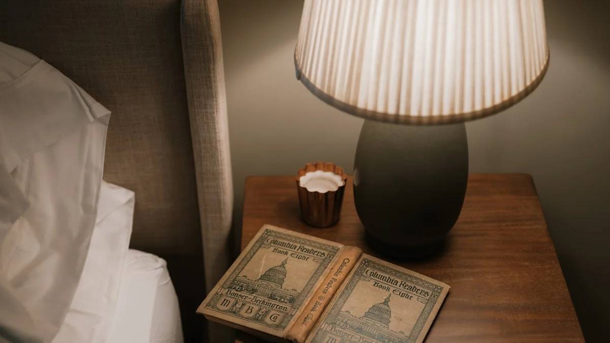 Open book on bedside table with lamp — a Sleep, Finally guide to Why Your To-Do List Pops Into Your Head at Night
