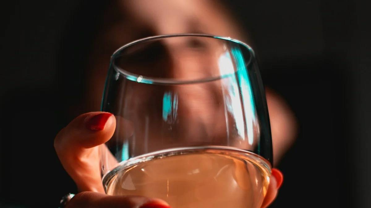 person holding clear wine glass — a Sleep, Finally guide to Women and Alcohol: Why Sleep Effects Hit Harder